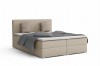 Sandfarbenes Boxspringbett mit grauer Bettwäsche und Zierkissen.