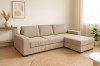 Ecksofa in Beige mit Cord-Bezug und L-Form in einem freundlich eingerichteten Wohnzimmer.