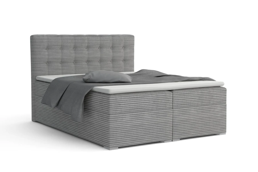 Graues Boxspringbett in Cord-Optik mit gepolstertem Kopfteil und grauer Bettwäsche.