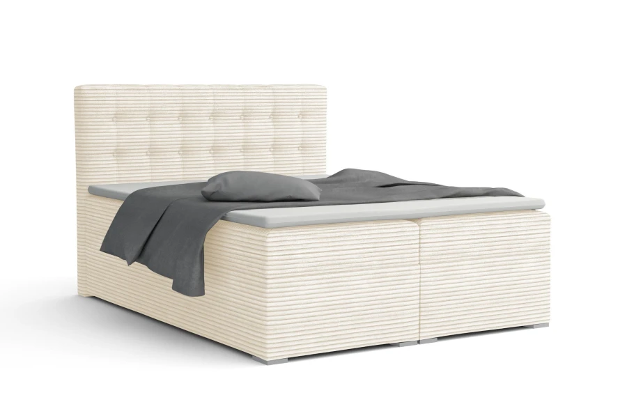 Cremeweißes Boxspringbett mit strukturiertem Cord-Stoff und elegantem Kopfteil.