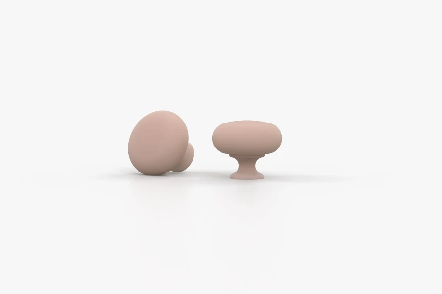 Two round, matt furniture knobs in pink as accessories for the Oskar collection.