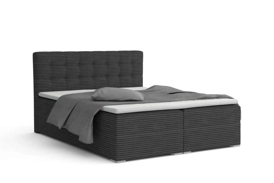 Dunkelgraues Boxspringbett mit Cordstoff-Struktur und hohem, gestepptem Kopfteil.