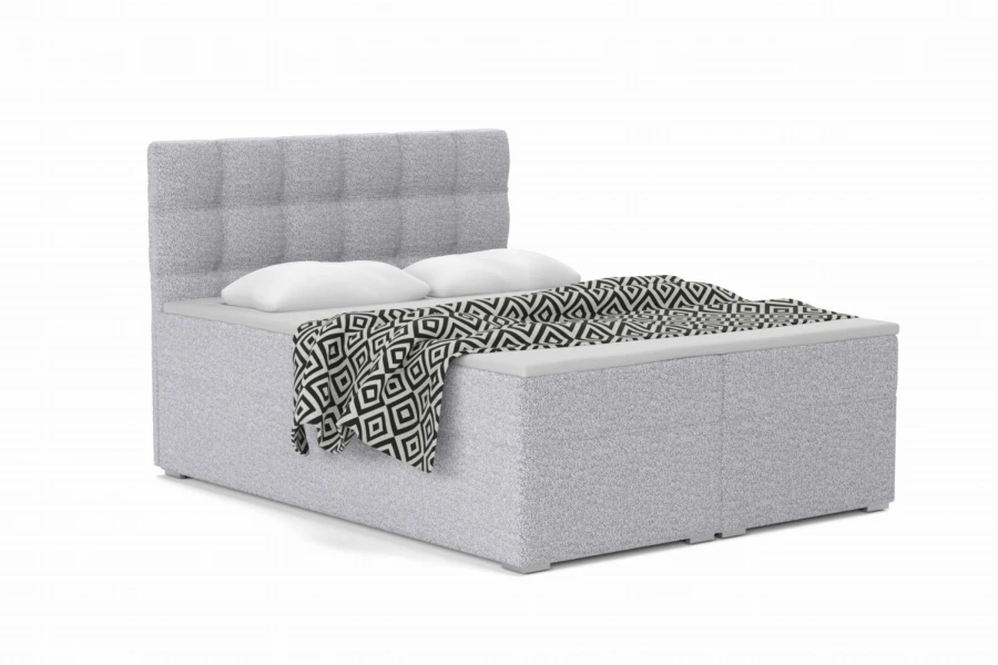 Modern grey box spring bed with quilted headboard and black and white bedspread.