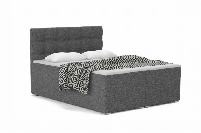 Elegant boxspringbed ABI in antraciet met gecapitonneerd hoofdbord, kussens en gedessineerde deken.