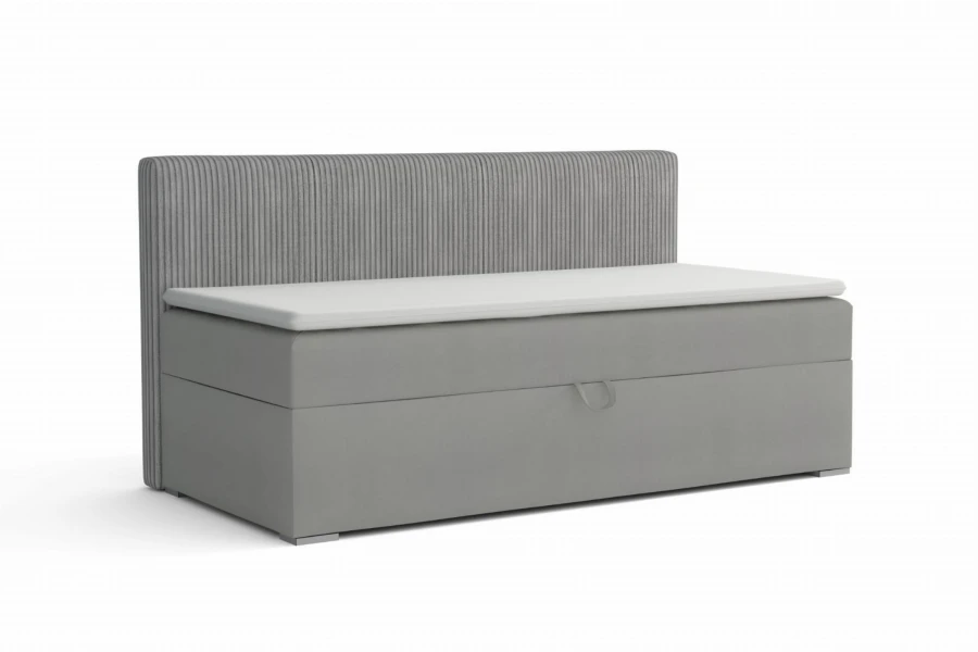 Modern grijs boxspring eenpersoonsbed met geribbeld hoofdbord en witte topper.