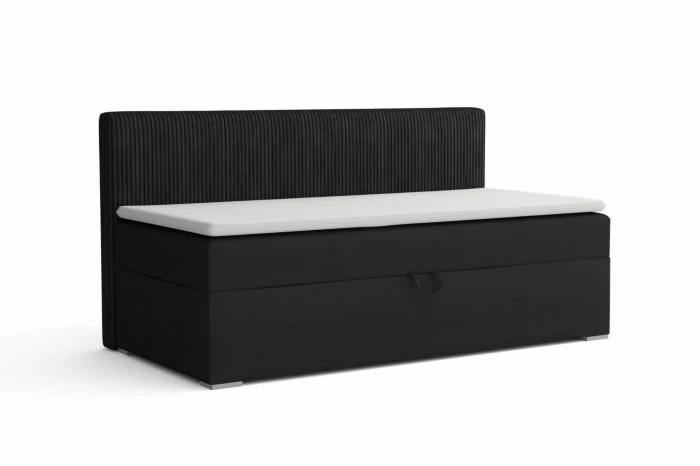 Modern black boxspring bed with ribbed headboard and white mattress.
