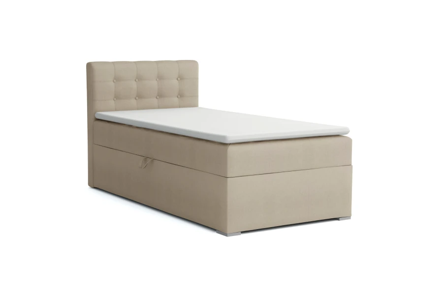 Beiges Boxspringbett mit Knopfsteppung am Kopfteil und Stauraum.