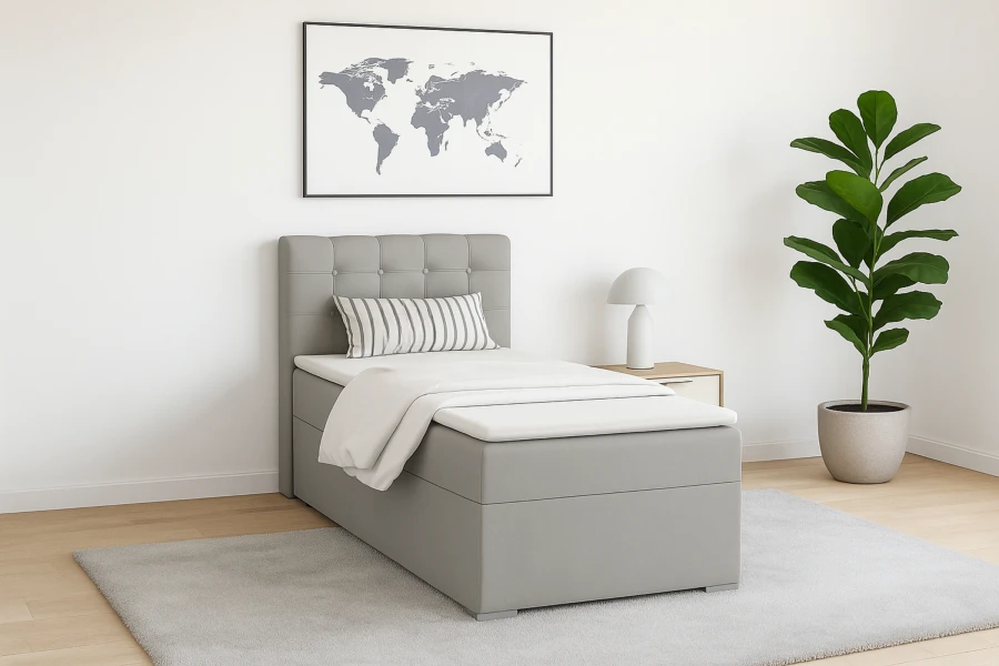 Graues Boxspringbett in modern eingerichtetem Schlafzimmer mit Wandbild und Zimmerpflanze.