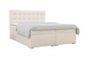 Elegantes beiges Boxspringbett mit gestepptem Kopfteil auf weißem Hintergrund.