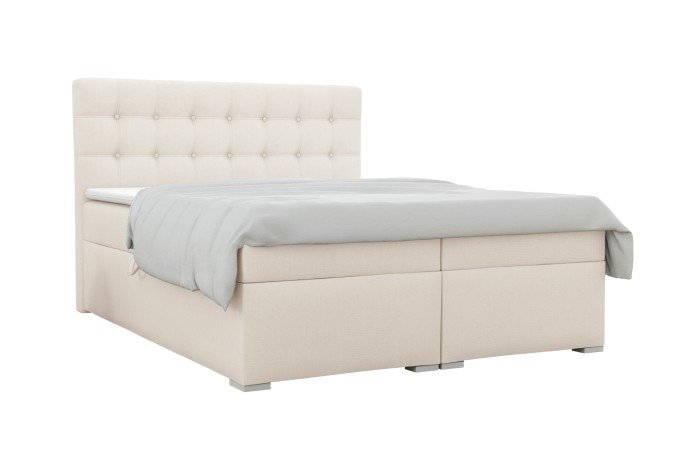 Elegantes beiges Boxspringbett mit gestepptem Kopfteil auf weißem Hintergrund.