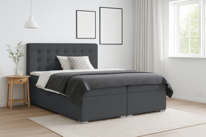 Dunkelgraues Boxspringbett im Schlafzimmer mit modernem gepolsterten Kopfteil.