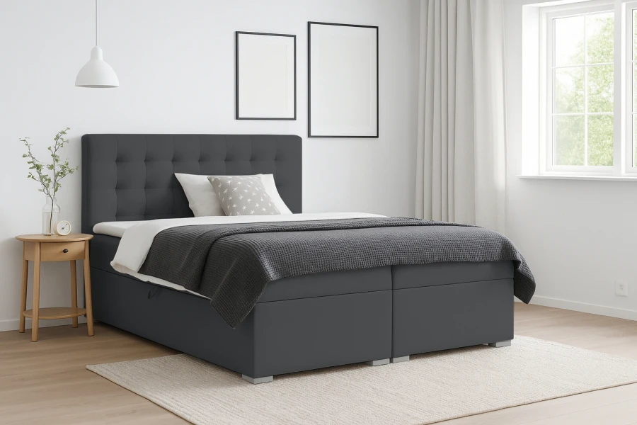 Modernes dunkelgraues Boxspringbett in einem hellen Schlafzimmer-Ambiente.