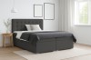 Modernes Boxspringbett in Anthrazit mit gestepptem Kopfteil und Bettkasten im Schlafzimmer.