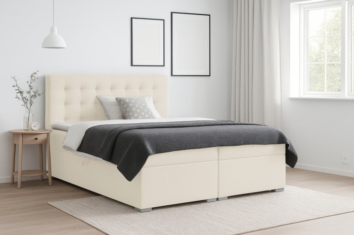 Modernes Boxspringbett LIVIA in Creme mit gestepptem Kopfteil in hellem Schlafzimmer.