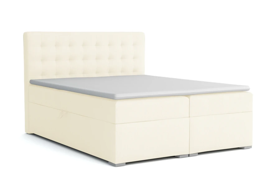 Beiges Boxspringbett mit gestepptem Kopfteil und Topper vor weißem Hintergrund.