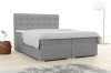 Modernes graues Boxspringbett mit gepolstertem Kopfteil in einem hellen Schlafzimmer.