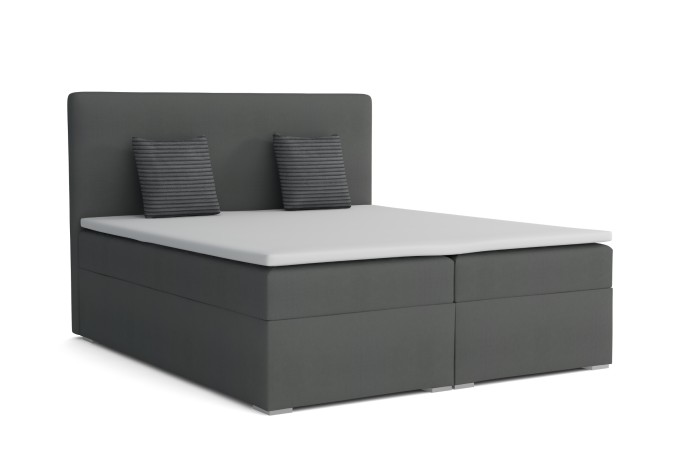Anthrazitfarbenes Boxspringbett auf weißem Hintergrund mit weißem Topper und zwei gestreiften Zierkissen.