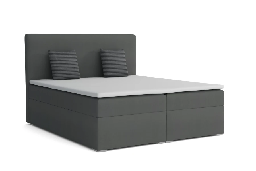 Modernes graues Boxspringbett mit Bettkasten und Kissen vor weißem Hintergrund.