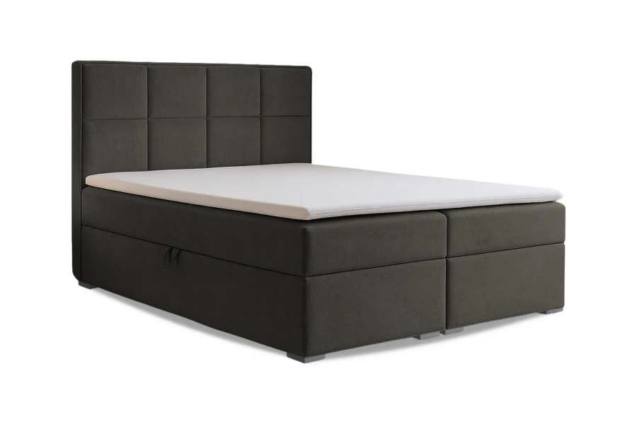 Anthrazitfarbenes Boxspringbett mit gestepptem Kopfteil und Topper vor weißem Hintergrund.