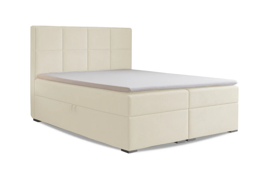 Freigestelltes Boxspringbett in Beige mit Topper auf weißem Hintergrund.