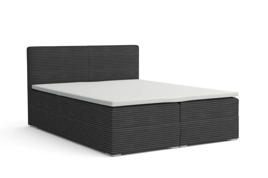 Graues Boxspringbett mit Cord-Bezug und weißem Topper auf weißem Hintergrund