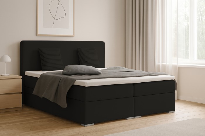 Modernes schwarzes Boxspringbett Bello in einem hellen Schlafzimmer.