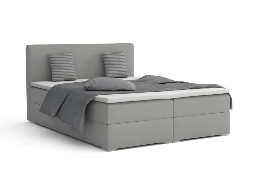 Grijs boxspringbed Bello met kussens en deken in elegante, strakke look voor de slaapkamer.