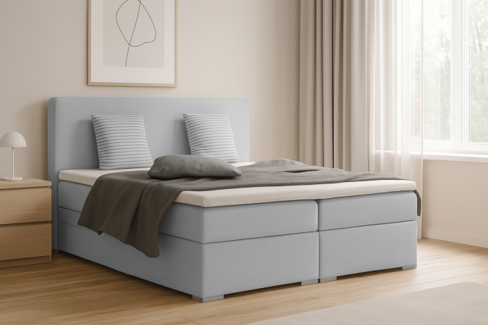 Side view of a light blue boxspring bed for stylish comfort in the bedroom.