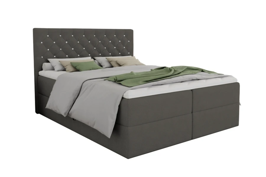 Dunkelgraues Boxspringbett mit gestepptem Kopfteil und Glitzersteinen vor weißem Hintergrund.