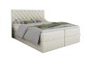 Cremefarbenes Boxspringbett mit Knopfheftung und Glitzersteinen auf weißem Grund.