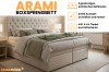 Arami Boxspringbett in Beige mit elegant gestepptem Kopfteil und integriertem Bettkasten.