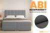 Grey ABI boxspring bed with dark grey fabric detail for a high-quality textured look.