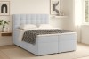 Modernes hellblaues Polsterbett in gemütlicher Schlafzimmer-Atmosphäre, Seitenansicht.