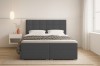 Dunkelgraues Boxspringbett in Frontalansicht mit elegantem Kopfteil und minimalistischer Einrichtung.
