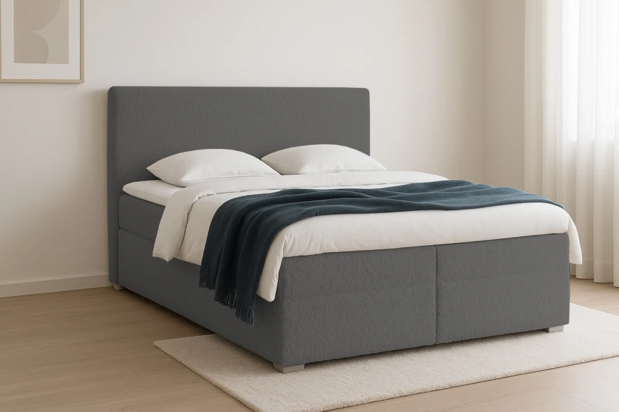 Seitenansicht eines grauen Doppelbettes auf einem hellen Teppich in modernem Design.