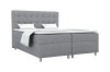Modernes Boxspringbett in Grau mit gestepptem Kopfteil und weißer Matratzenauflage.