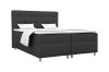 Anthrazitfarbenes Boxspringbett mit gestepptem Kopfteil und weißer Bettwäsche.