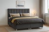 Dunkelgraues Boxspringbett in modernem Schlafzimmer mit gemütlicher Dekoration.