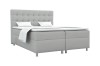 Graues Boxspringbett mit modernem Steppkopfteil freigestellt vor weißem Hintergrund.