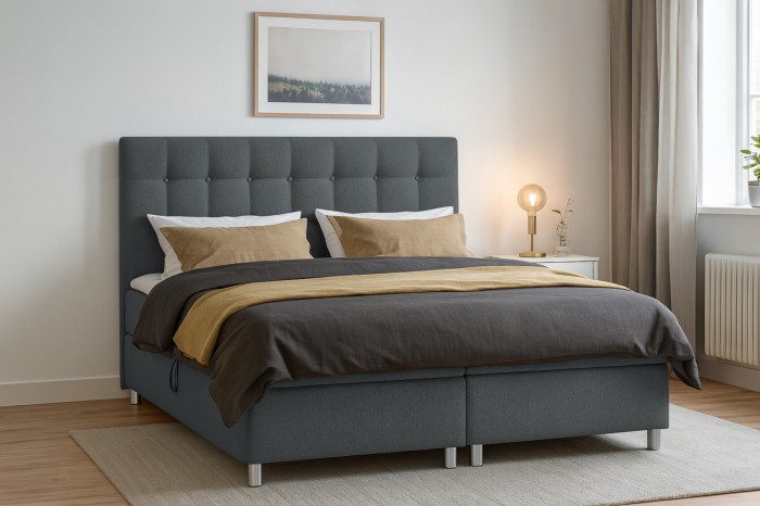 Modernes Boxspringbett Brill in Grau in einem hellen Schlafzimmer mit gemütlicher Dekoration.