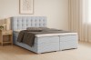Zeitloses Boxspringbett in Hellgrau mit Cord-Struktur und gepolstertem Kopfteil.