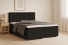 Dunkelgraues Boxspringbett Cynthia aus Cord-Stoff mit hohem Kopfteil und Bettkasten im hellen Raum.