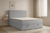 Light blue boxspring bed DAGA with padded headboard and two practical bed boxes in the bedroom.