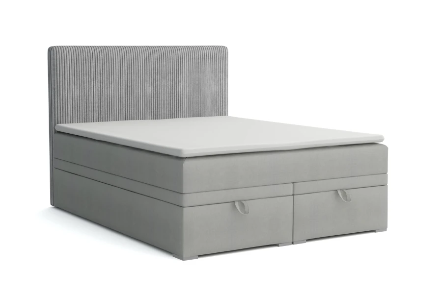 Modern grijs boxspringbed met geribbeld hoofdbord en geïntegreerde opbergruimte op een witte achtergrond.