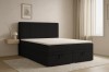 Black Daga boxspring bed in a bright, modernly furnished bedroom.