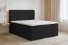 Modernes schwarzes Boxspringbett mit weißem Topper im hellen Schlafzimmer.