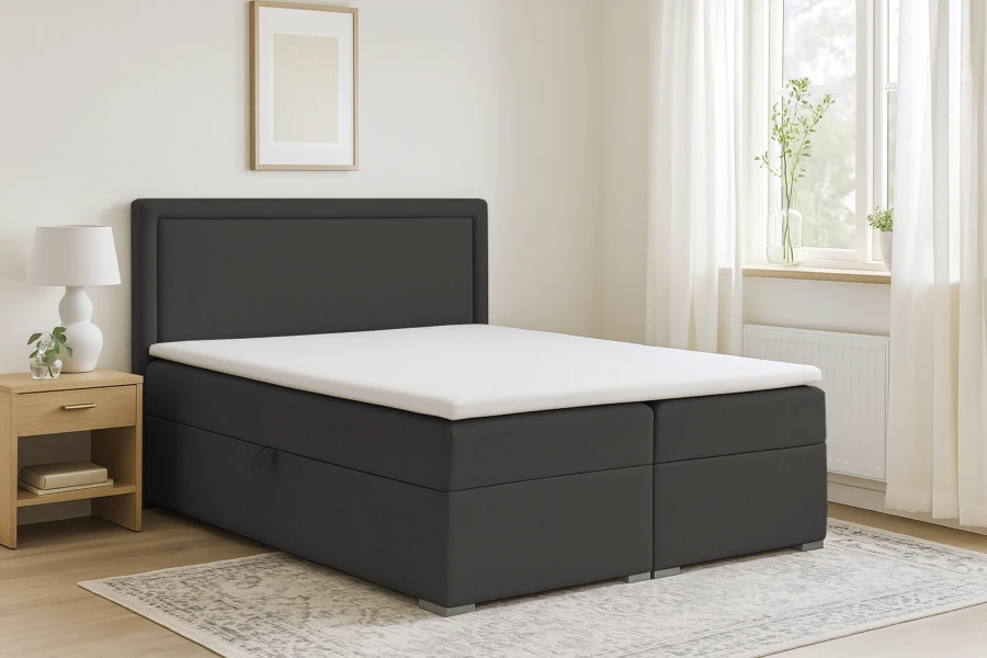 Dunkelgraues Boxspringbett Dream im gemütlich eingerichteten Schlafzimmer.