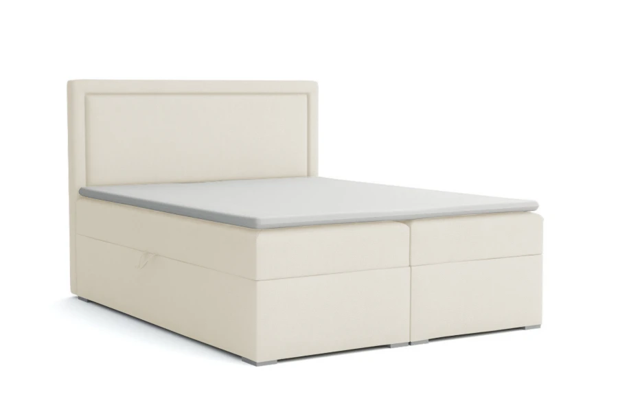 Modernes Boxspringbett in Creme mit gepolstertem Kopfteil vor weißem Hintergrund.