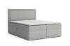 Freigestelltes hellgraues Boxspringbett mit hohem Kopfteil und weißem Topper.