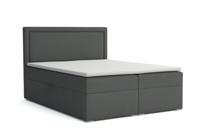 Graues Boxspringbett Dream mit weißem Topper und modernem Polster-Kopfteil.